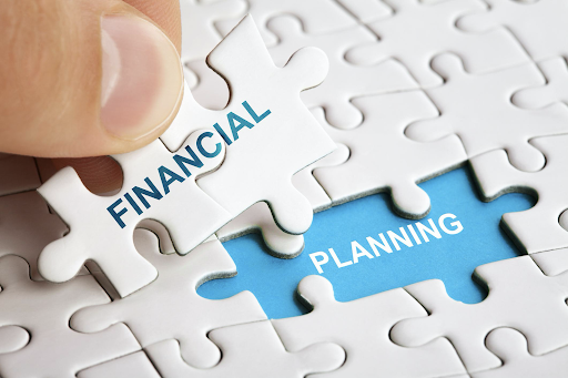 final puzzle pieces being placed with words financial planning on them