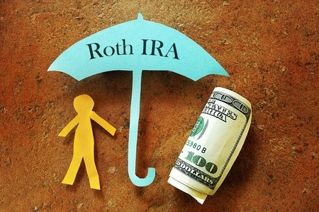 A bundle of money, a person under and umbrella of their Roth IRA